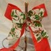 Holly Berry bow set on a red ribbon background