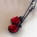 Deep red vintage rhinestone earrings with Fallen Angel Brass components