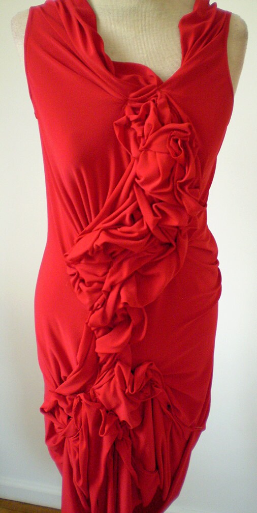 Red jersey dress with fabric manipulationhemline is by Cheryldine