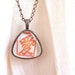 Love. Triangular copper necklace handprinted in red