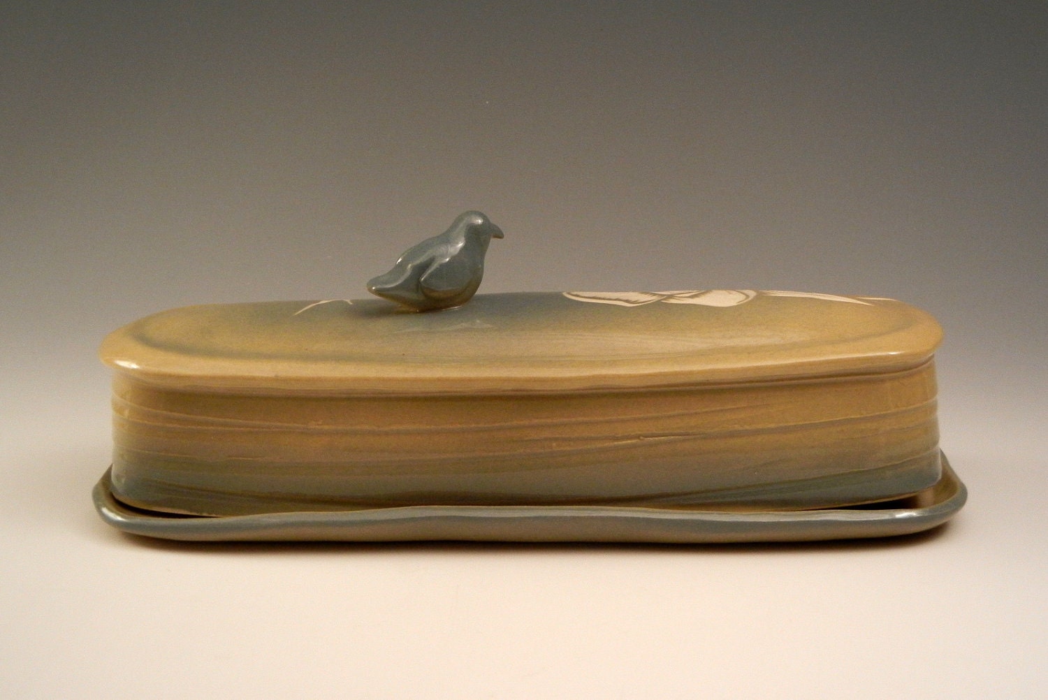 Blue and green ceramic butter dish with magnolia flower