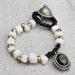 Elastic ethnic beads bracelet in Ivory shell beads and black seed beads/eclectic/nomadic/hippie/flea market finds /Boho chic /one of a kind
