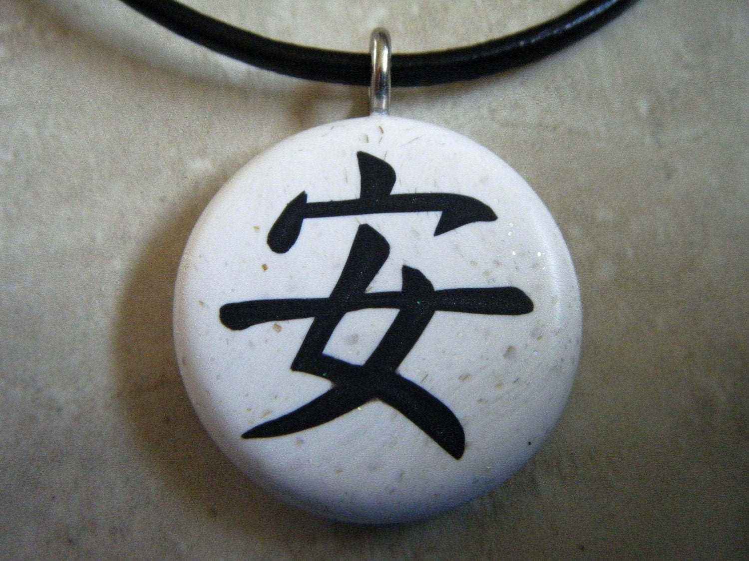 Japanese kanji symbol for PEACEFULSAFE hand carved on a