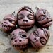 Super creepy mini shrunken head charms. Frightening, crazy and lovely at the same time