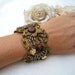 Mintook- Vintage Bracelet, with flat bourgondy beads , gold color metal flowers and long work beads, all stitched to a ribbon lace.