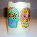 4" Flameless unscented pillar candle with 2 bright colored Sugar Skulls