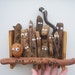 Quirky family tree folk art piece with old fashioned beer tab hanger.