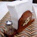 Vintage salt, pepper and napkin caddy in brown natural wood with daisies for a cottage chic organized kitchen table or eating area.
