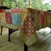 Cotton Tablecloth, 59X91 inches. Made up of six inch squares. Blues, Reds, Yellows