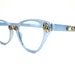 TURA sky blue cat eye glasses. gold embellishments. ornate. 1950s retro eyewear. aluminum and gold. no lenses. (VFAC)