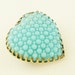Art deco embossed turquoise glass heart brooch in aged brass