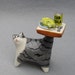 cat serves fish dinner, ceramic sculpture miniature