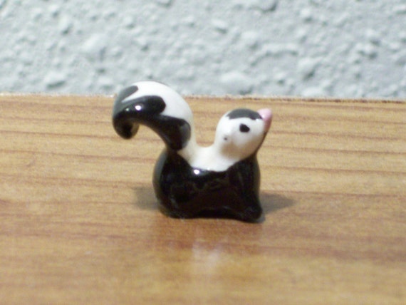 ceramic skunk figurines