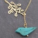 Bird in a branch lariat in gold