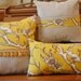 Yellow on black bird on a branch pillow collection