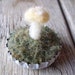 Felted wool yellow amanita mushroom in a white bottlecap