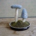 Felted wool garden, pale blue amanita mushrooms in an upcycled lid