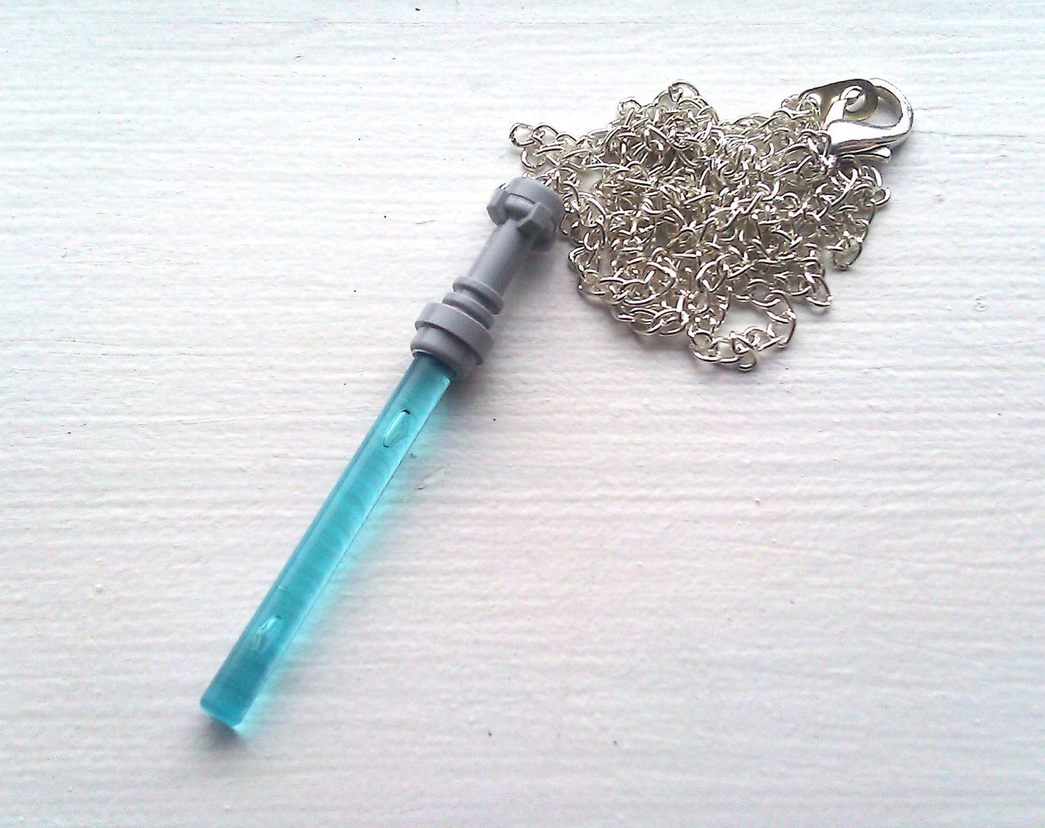 LIGHT BLUE Star Wars Lightsaber Necklace by hippopotamuspie