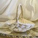 Burlap Vintage Flower Girl Basket handmade of ivory burlap and embellished with light ivory lace and soft white and light ivory flowers.