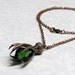 Steampunk Raven Claw Pendant with Emerald Green Stone