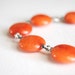 Orange Beaded Bracelet. Oxidized Sterling Silver. Lotus Charm