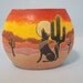 Southwestern Sun Raise Pillow Vase with oranges, yellows and reds in the sky