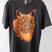 Black and Orange Mutant Cat T Shirt. SMALL