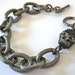 Textured gunmetal link bracelet with black pave skull charm