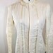 1970s Gunnies by Jessica Mc Clintock Ivory colored lace and ribbon quilted Gothic Lolita jacket.