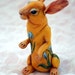 SALE. Yellow rabbit embracing by blue tulips. Polymer clay hand painted miniature