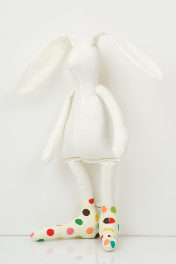White Small rabbit Wearing a colorful polka dots socks