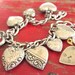 Beverly's charm bracelet with 8 puffy Victorian sterling silver hearts and padlock on a chain, Marine Corps sweetheart jewelry