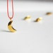 Gold plated crescent necklace with silk cord