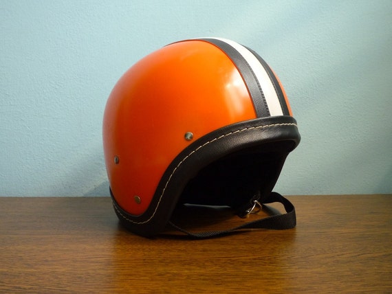 Vintage motorcycle orange helmet black white stripes