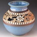 Vase With Flowers, Swirl Design, And Soft Blue Border Of Squares