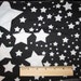White Stars on Black Knit Fabric