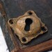 Vintage primitive brass key hole escutcheon.