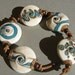 Handmade lampwork glass lentil beads "Spring lentils" in ivory and blue by Flamejewels.