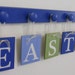 Baby Nursery Wall Letter Sign Set Includes 6 Wooden Pegs Kids Name EASTON in Blue and Light Green Alphabet Letters for your Bedroom Wall