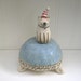 Sweet Little Dog in Party Hat Sitting on Ottoman Ceramic Sculpture
