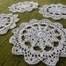 Set of four crochet white doilies