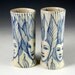 Blue and white faces bud vase pair