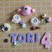 Fondant Tea Set, Tea Cups, Cookies, Cupcakes, Flowers and the Birthday Kid's Name and Age Cake Decorations