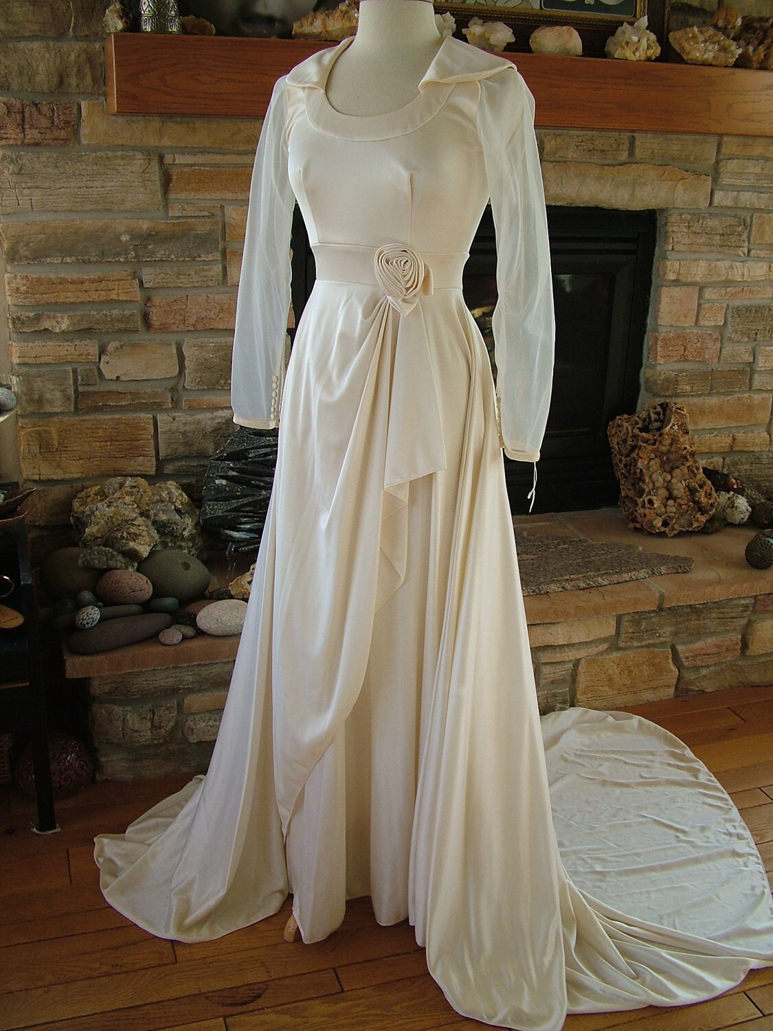 A vintage ivory 1970s wedding dress with a flowing silhouette and intricate lace details