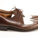 Brown and white two tone wing tip shoes