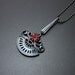 Goth style pendant with a red garnet