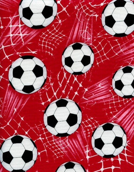 Cotton novelty quilt fabric soccer balls on a red background