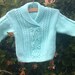 Child's boy girl toddler handknit pale green aran cable sweater with shawl collar.
