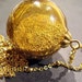 Golden Sparkle Globe - Necklace