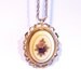 Victorian Style Necklace with a lavender purple flower on the front